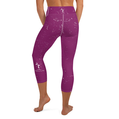 rear view of a barefoot woman wearing mauve colored yoga pants with white flecks